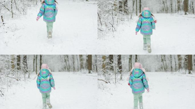 小女孩在冰雪覆盖的冬季公园里奔跑