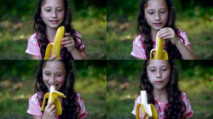 美丽的小女孩在花园里吃香蕉