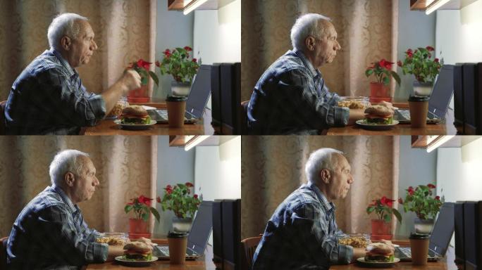 一位老人在家里吃爆米花，用电脑看电影