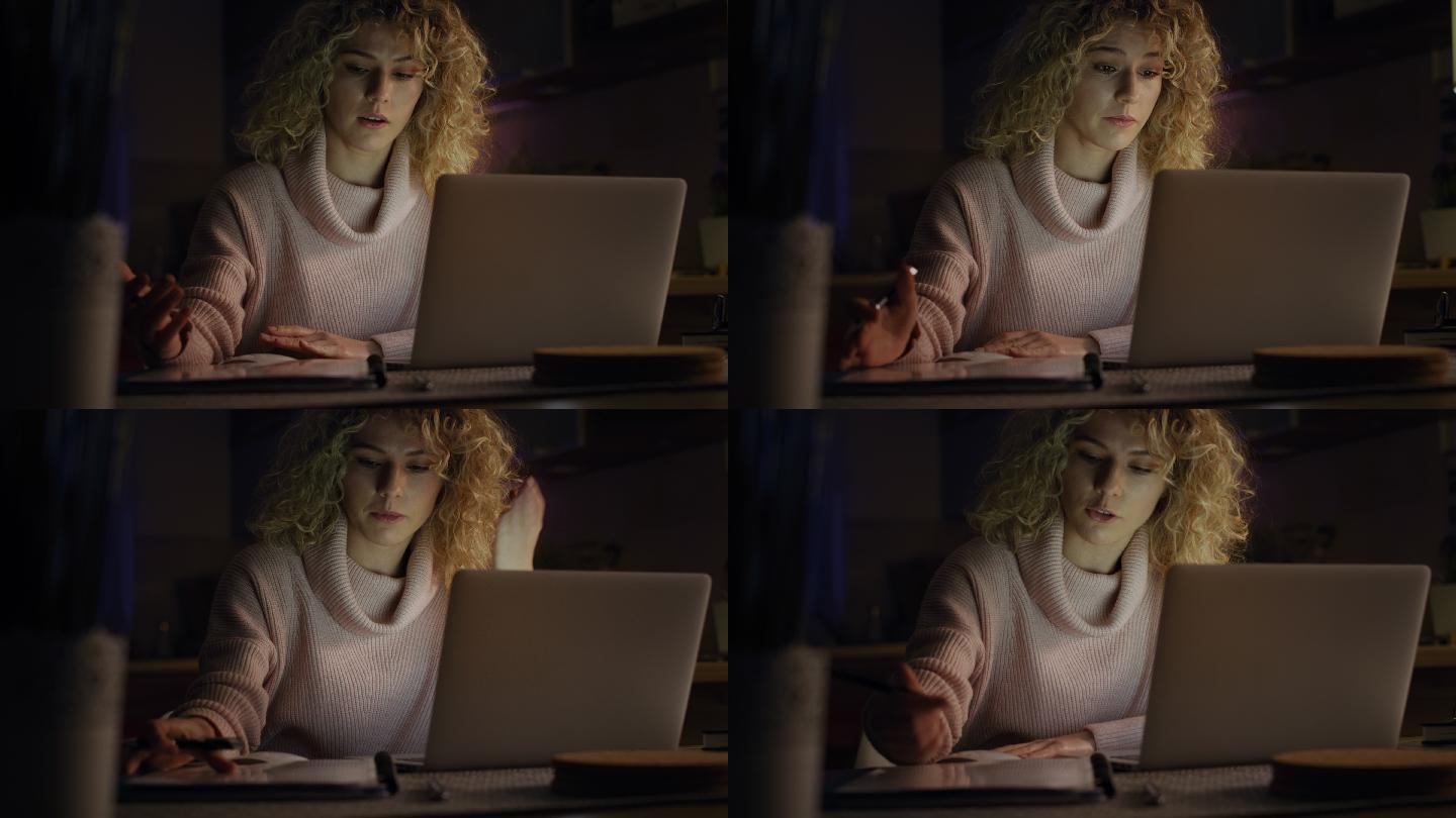 一名女子深夜在使用笔记本电脑