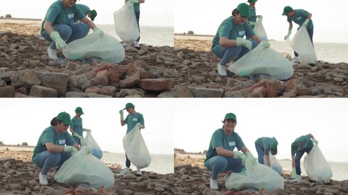 三名志愿者在清理海岸