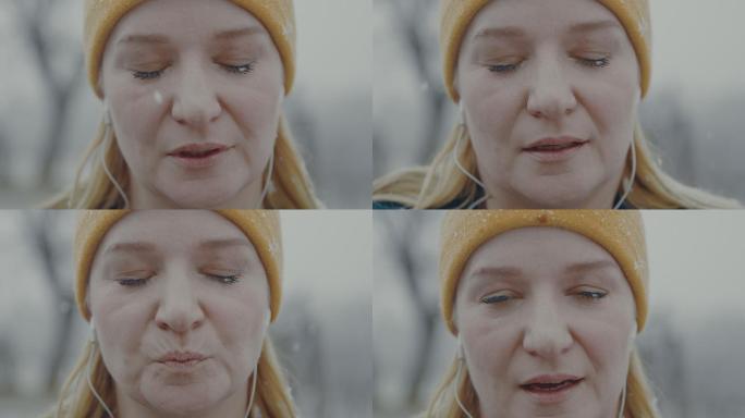 一个女人闭上眼睛在雪地里摆姿势
