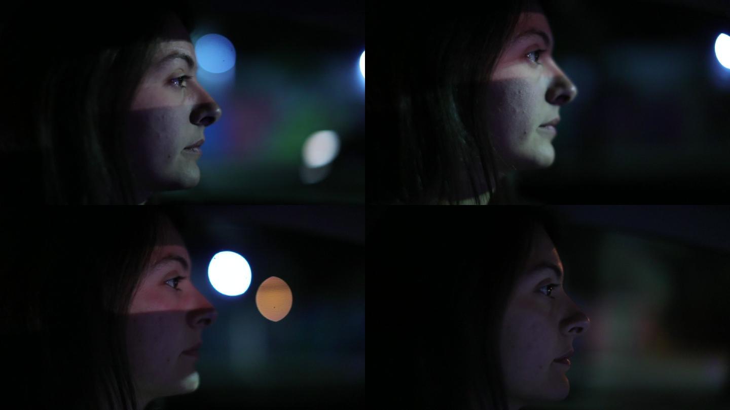 女性夜间驾车的特写镜头。