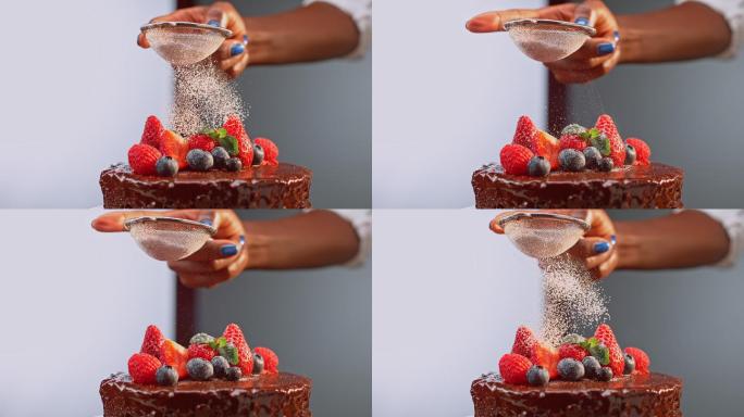 女性在巧克力蛋糕上撒糖霜