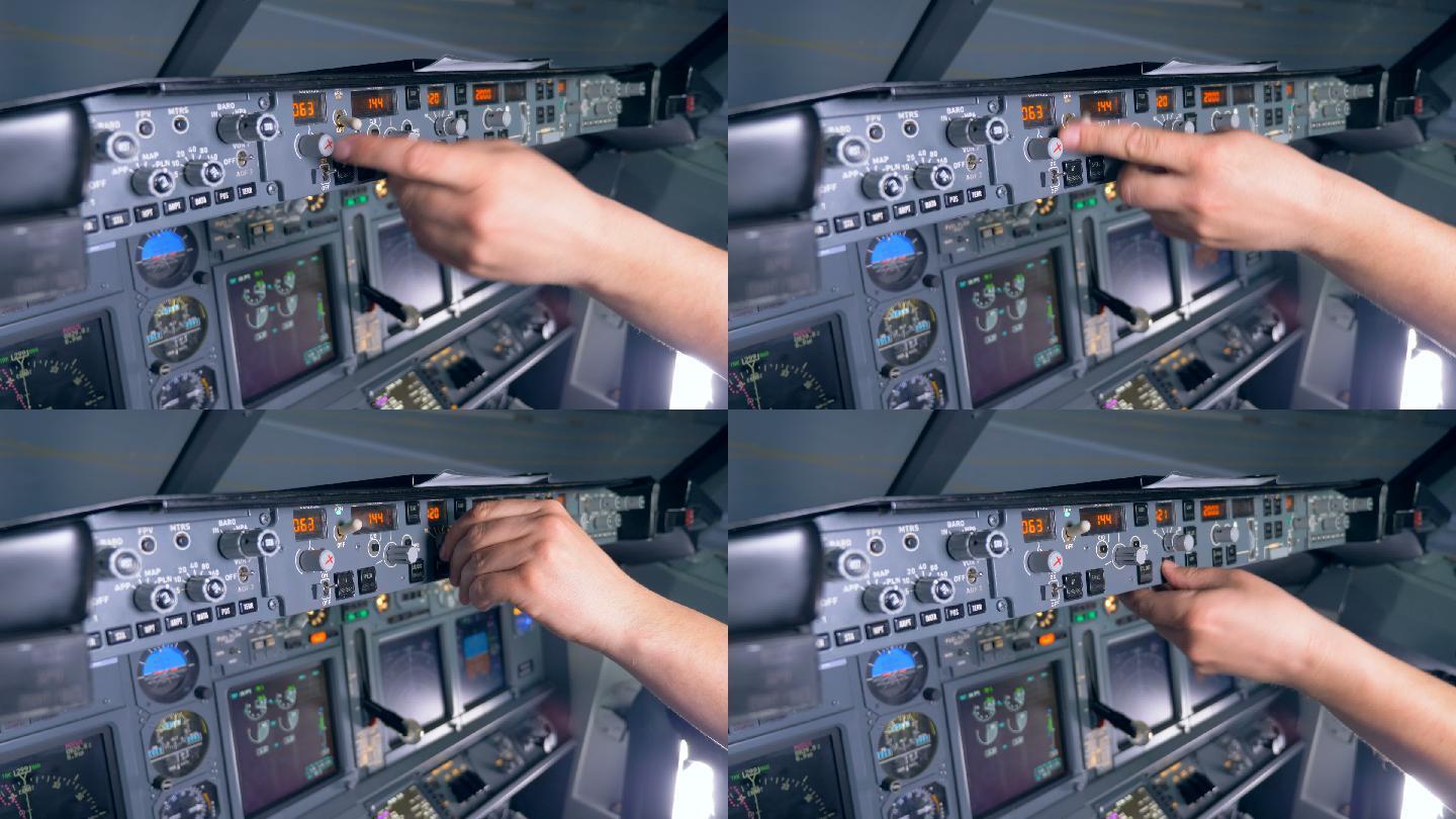 一架飞机控制台上的多个按钮被飞行员按下