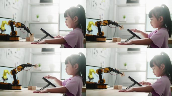 使用数字平板电脑用手控制机械臂的女孩