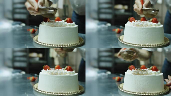 用草莓和糖霜装饰蛋糕的面包师