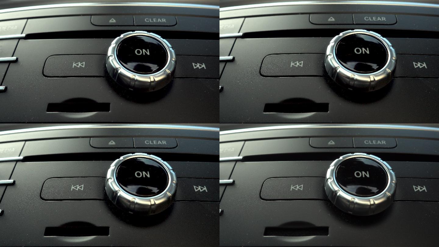 在豪华轿车上，手动按下On按钮打开收音机