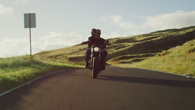 迷人的情侣骑着复古摩托车