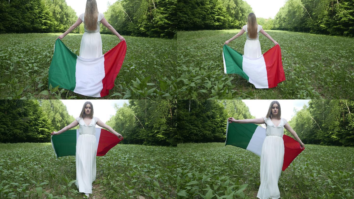 举着意大利国旗走在草地上的女人