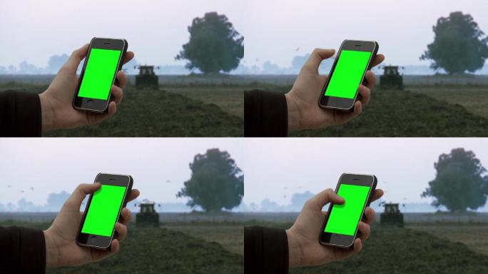 男子在农村田野使用手机