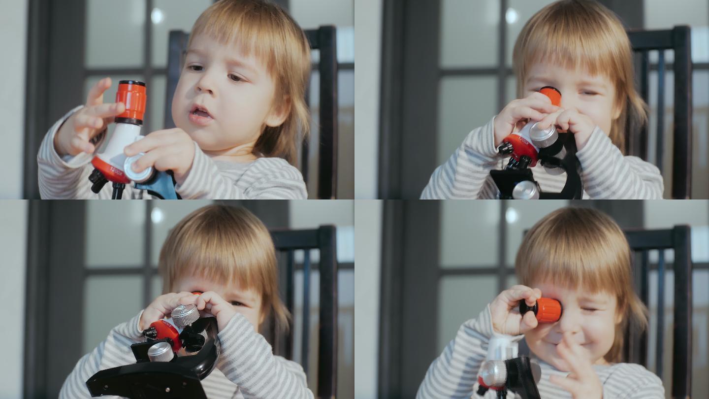使用玩具婴儿显微镜的可爱的男孩