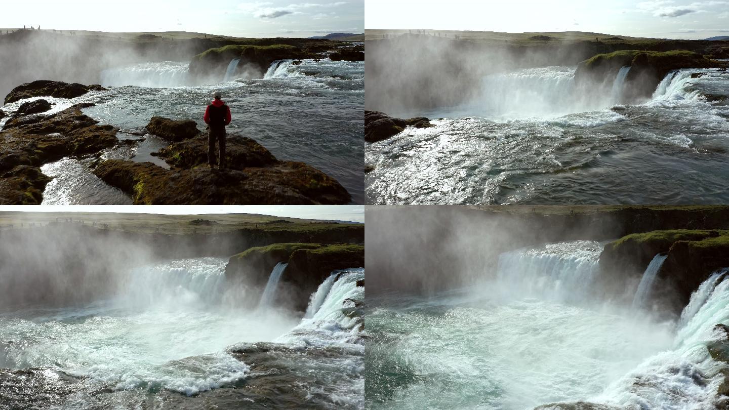 年轻人在看冰岛的戈达福斯瀑布
