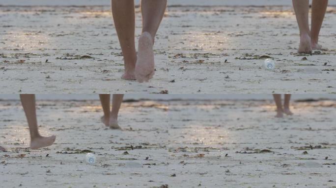 男子将塑料瓶扔到海滩上，女子将其捡起来