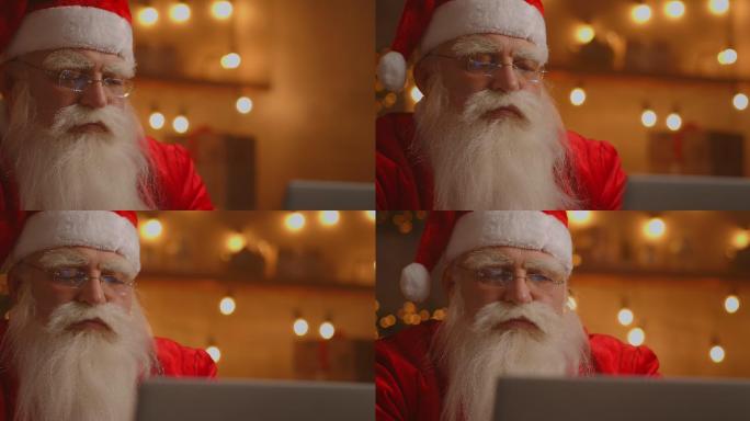快乐的圣诞老人在笔记本电脑上工作