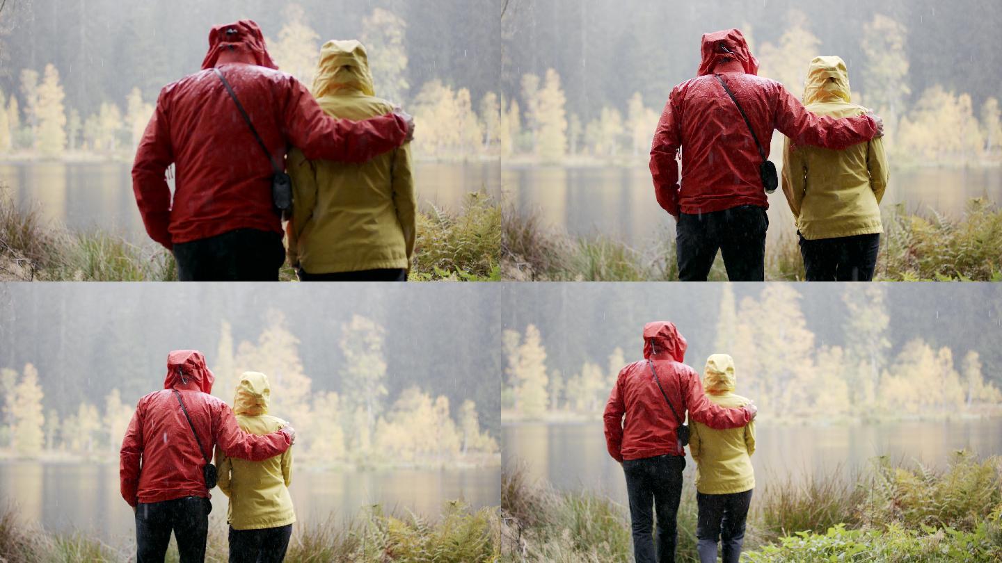 雨天，男人和女人在湖边欣赏风景
