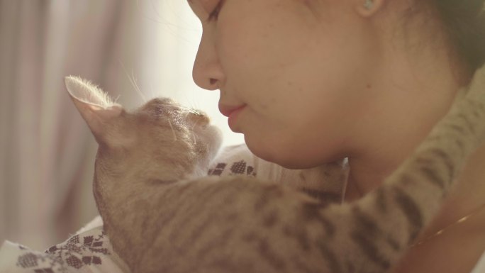 女人拥抱和亲吻她的宠物小猫