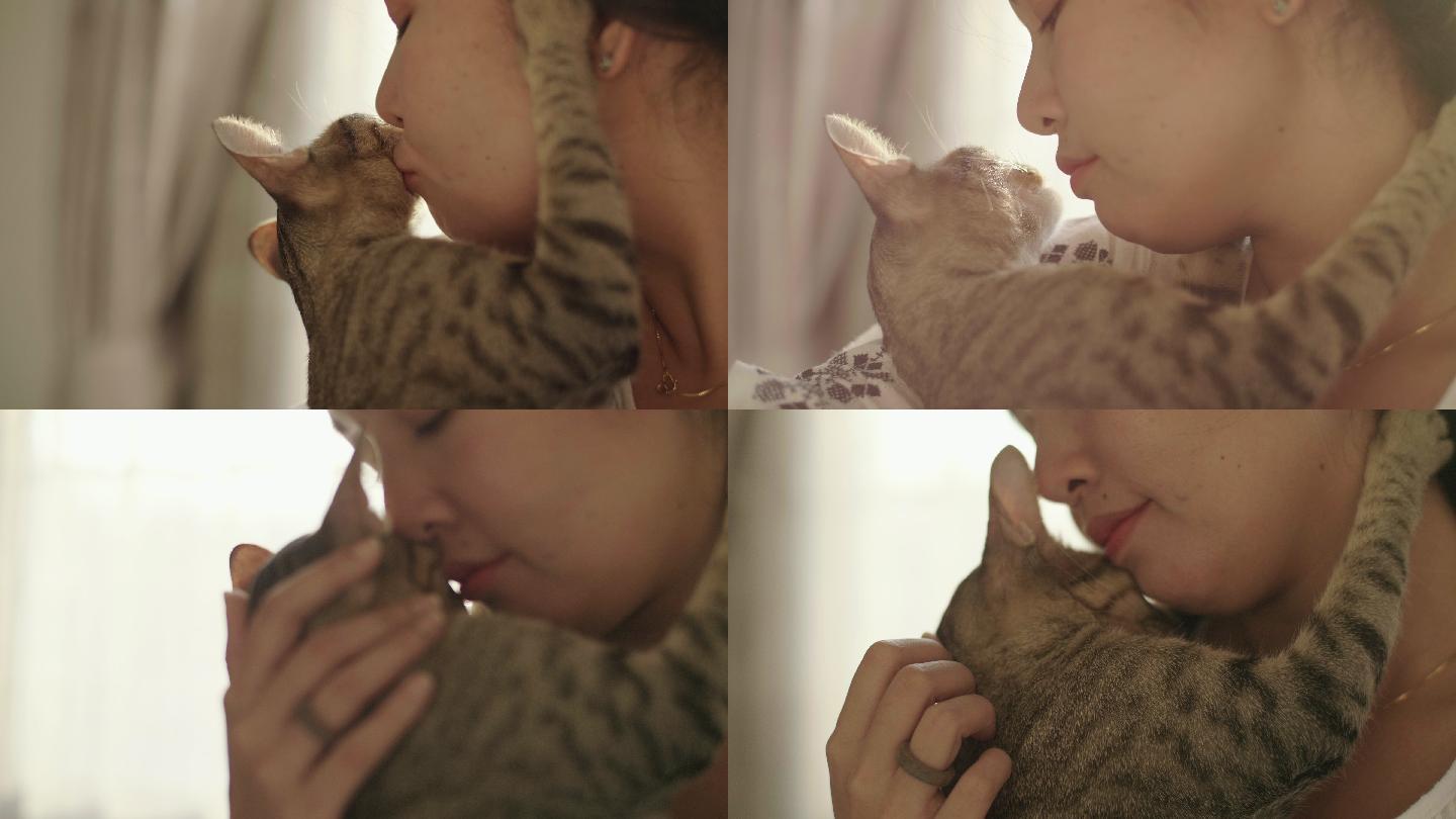 女人拥抱和亲吻她的宠物小猫