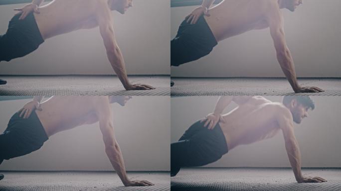 运动型男子在健身房做单手俯卧撑运动