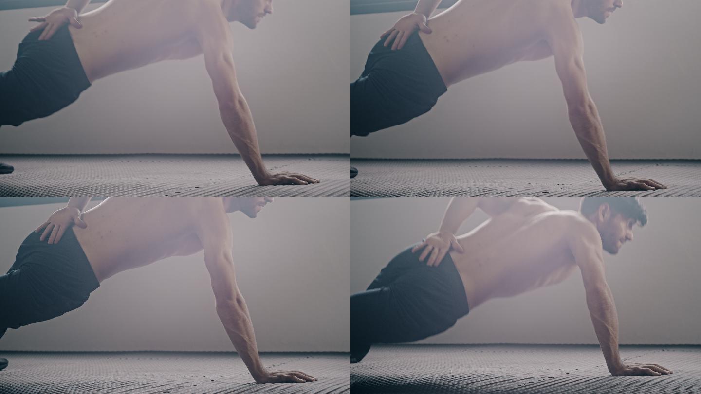 运动型男子在健身房做单手俯卧撑运动
