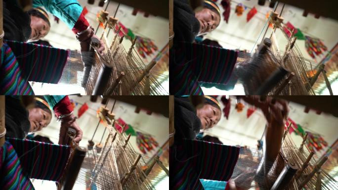 织布的藏族妇女操作纺织机