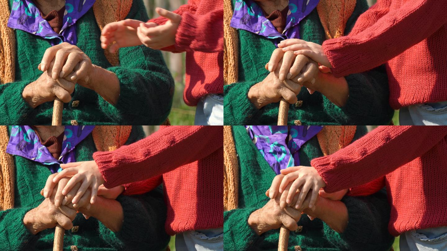 孩子握住老年妇女的手