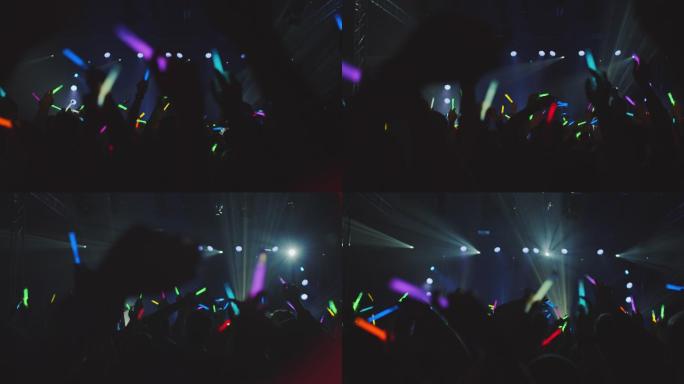 音乐会上的人群挥舞着各种颜色的荧光棒