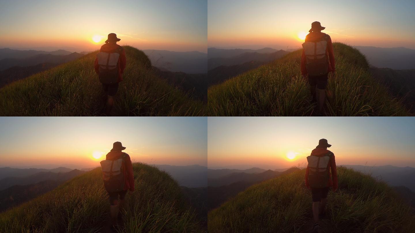 山脊上的男性冒险朝阳日出群山峻岭山岭