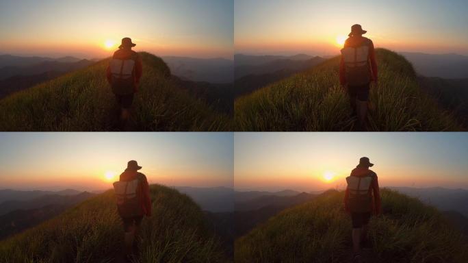 山脊上的男性冒险朝阳日出群山峻岭山岭