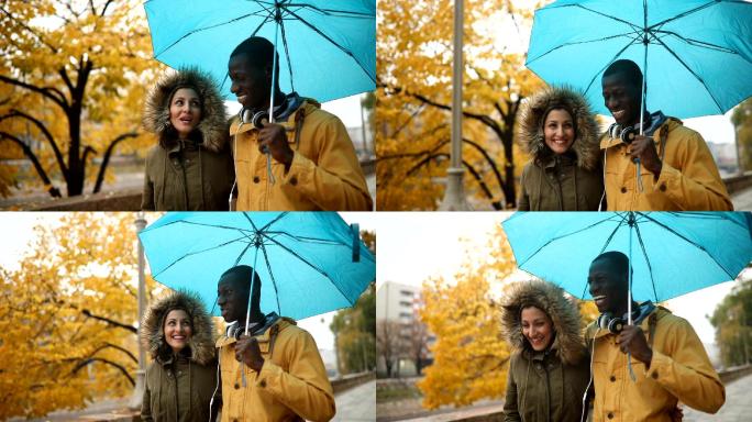 一对夫妇在雨中散步、共用雨伞