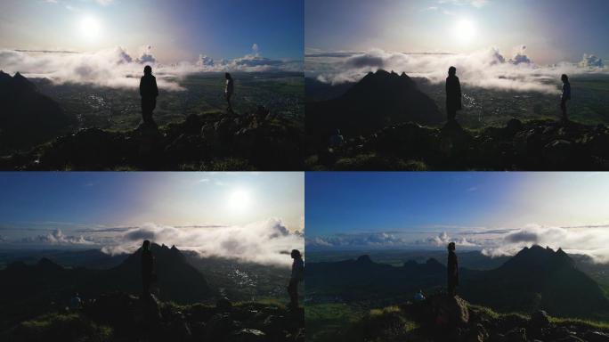 两人站立在险峻的山峰上观云海日出航拍素材