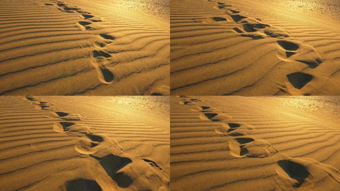 夜晚沙漠中沙丘上的脚印