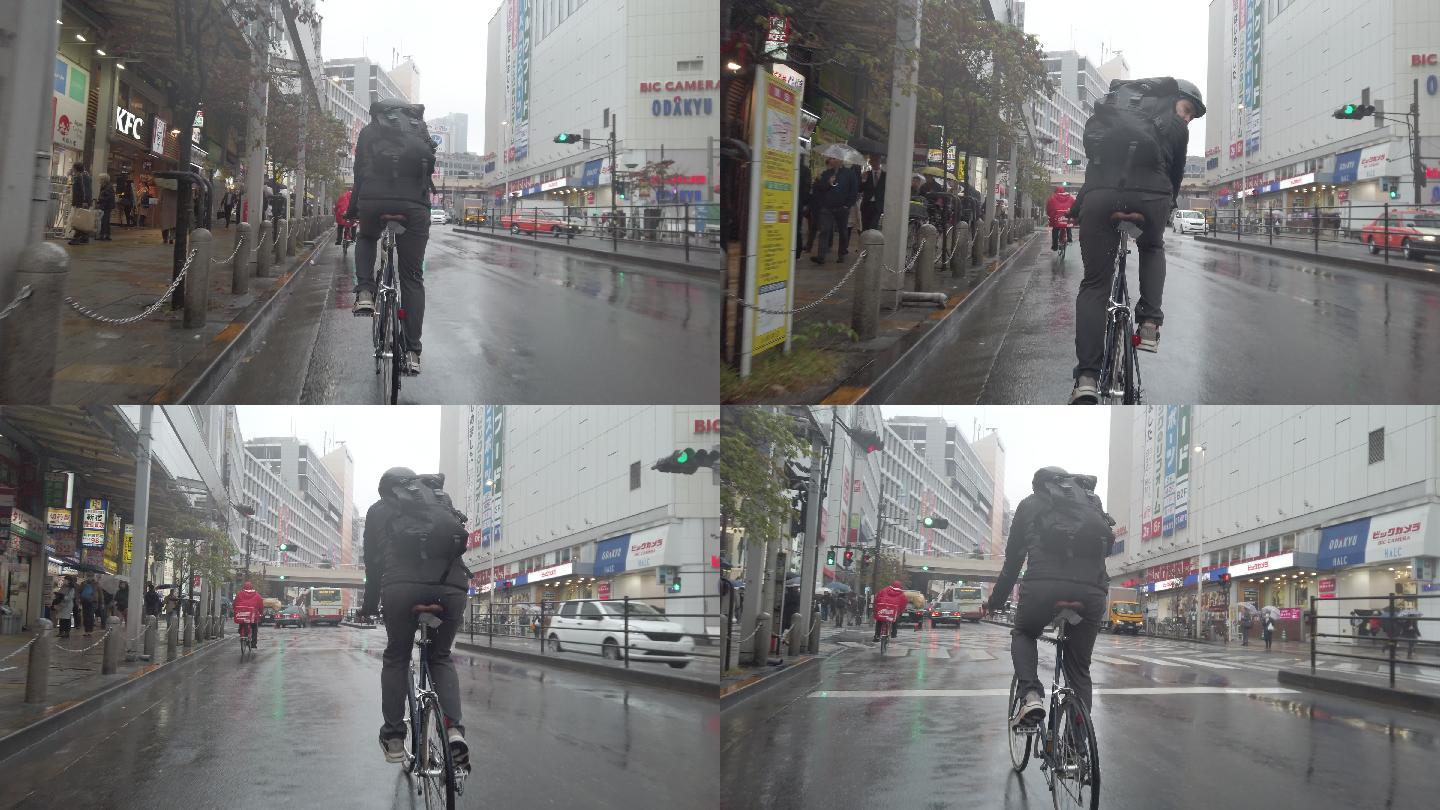 雨天在街道上骑自行车的男人
