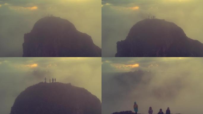 一群人站在险峻的山峰上观云海日出航拍素材