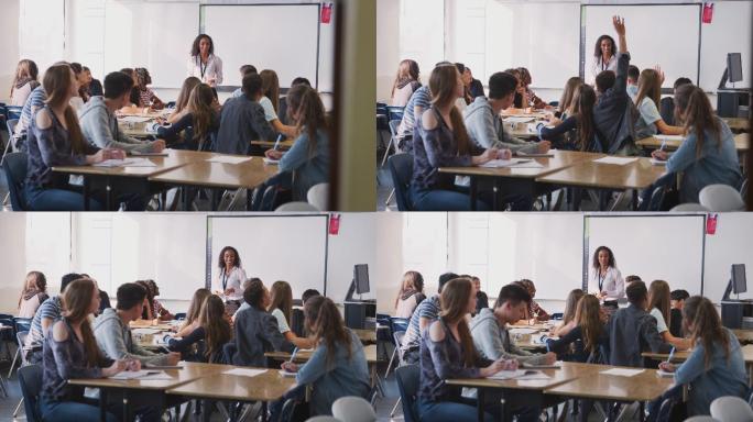高中女教师站在互动白板教学课旁提问