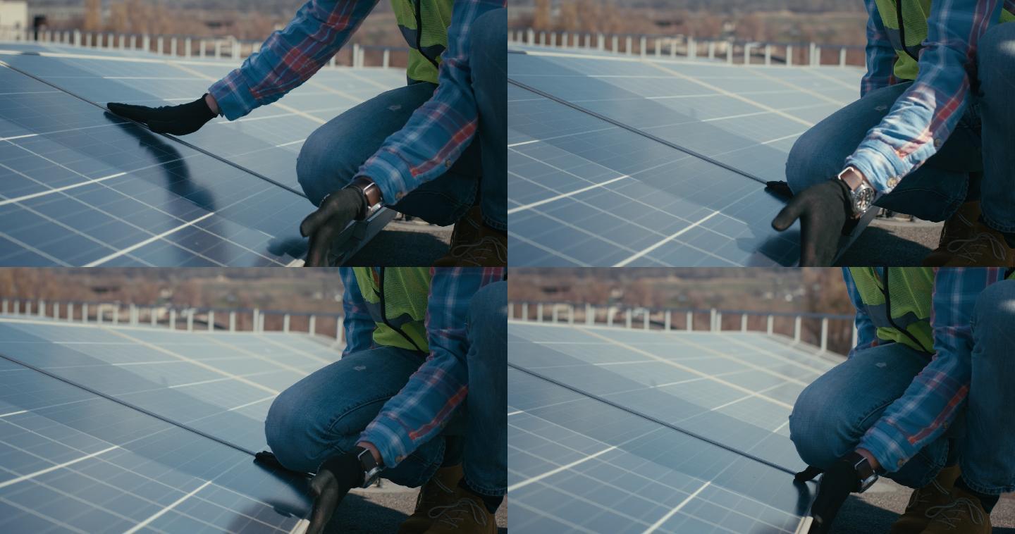 技术人员在金属支架上安装太阳能电池板