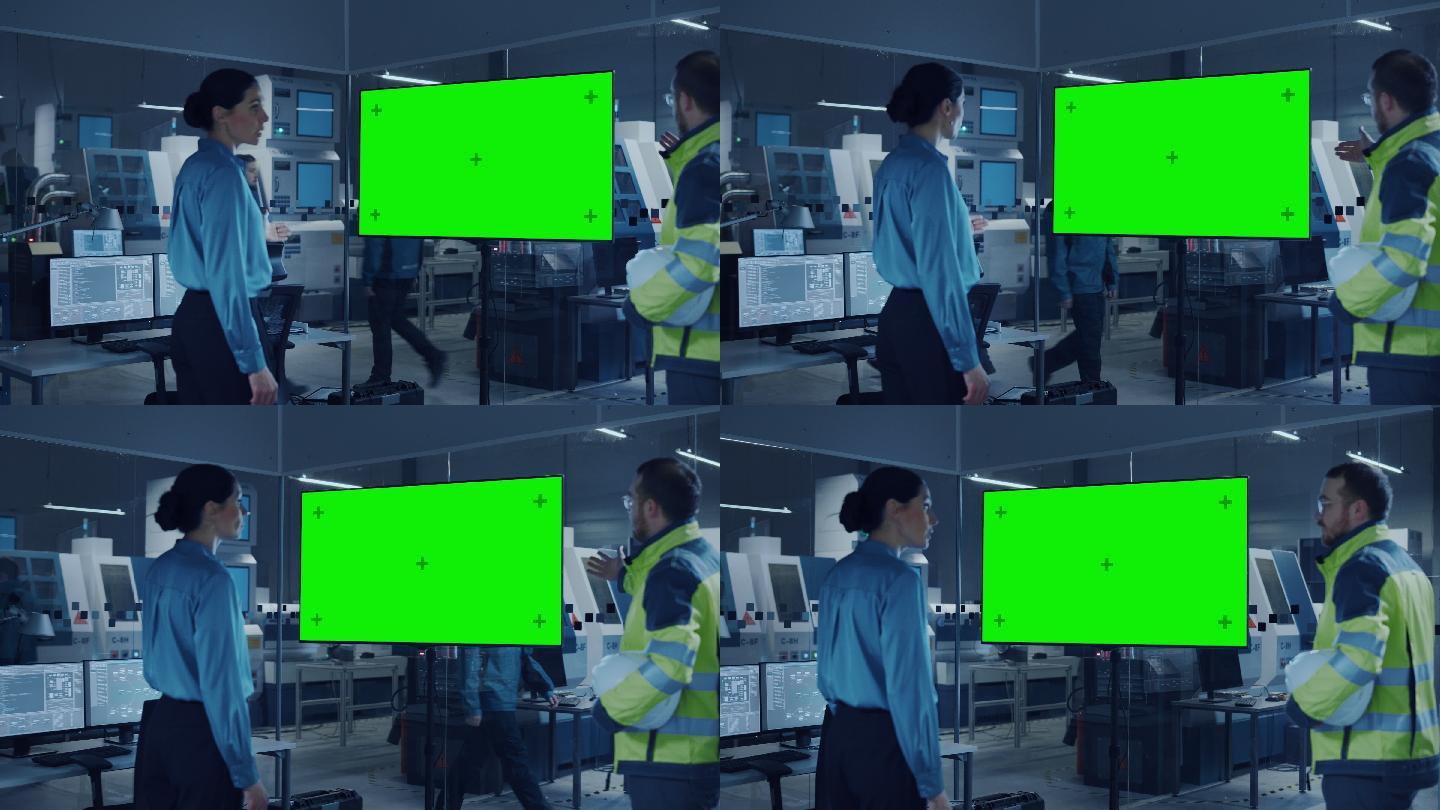 工程师观看显示绿色屏幕的数字白板电视。