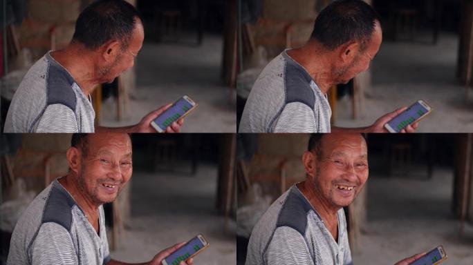 老人使用智能手机露出笑脸视频素材