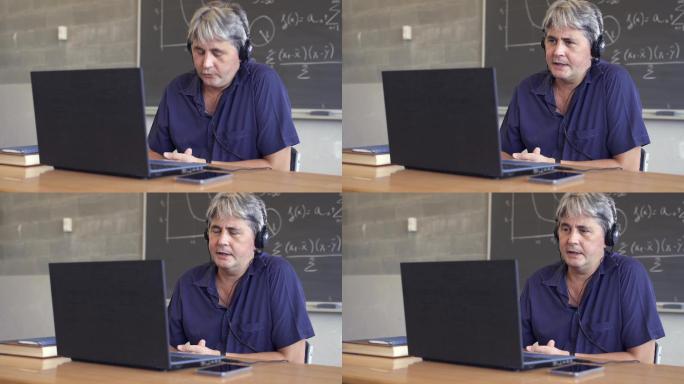 数学教授使用笔记本电脑与学生视频聊天。