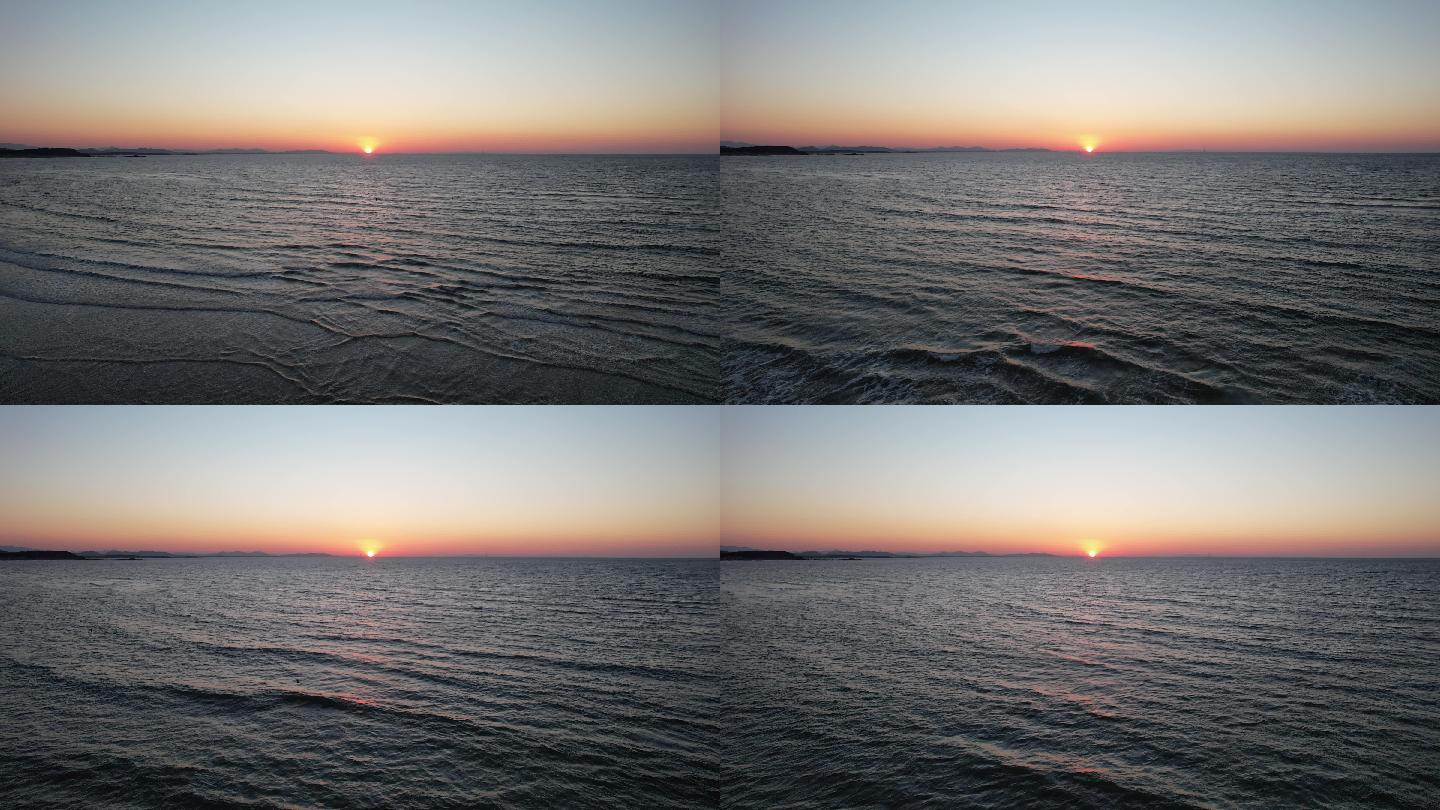 航拍海面上的夕阳西下和海鸥