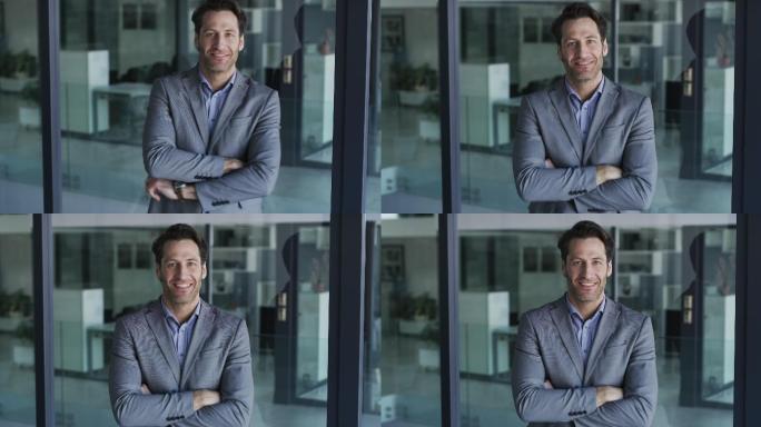 一个成熟商人双臂交叉站在办公室