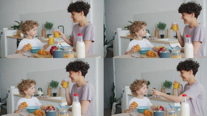 在家吃早餐的母子儿童小孩橙汁