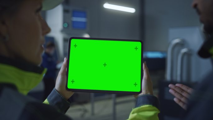 总工程师和项目主管使用绿色屏幕的数字平板