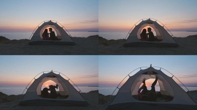 这对幸福的夫妇在海边的露营帐篷里。