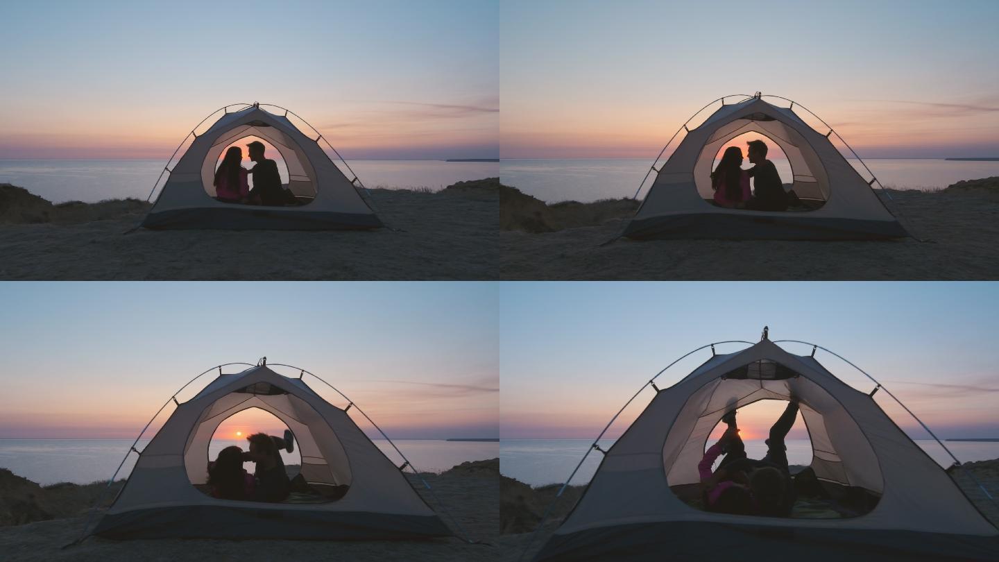 这对幸福的夫妇在海边的露营帐篷里。