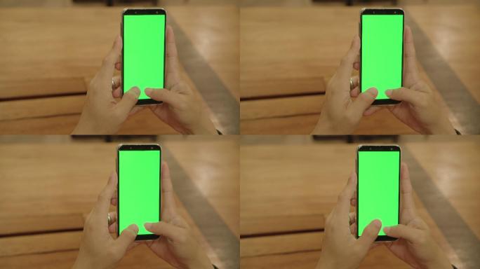 男子手持带绿色空白屏幕的智能手机