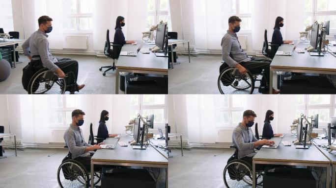 轮椅上的男子残疾人就业中心办公电脑工作上