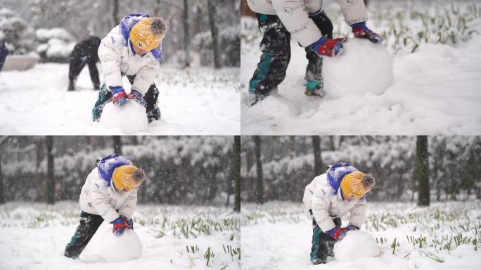 帅气小男孩雪地里滚雪球