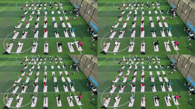 航拍妇女户外体育运动场习练瑜伽健身
