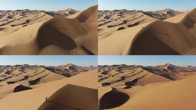4K航拍巴丹吉林沙漠沙丘行走人物